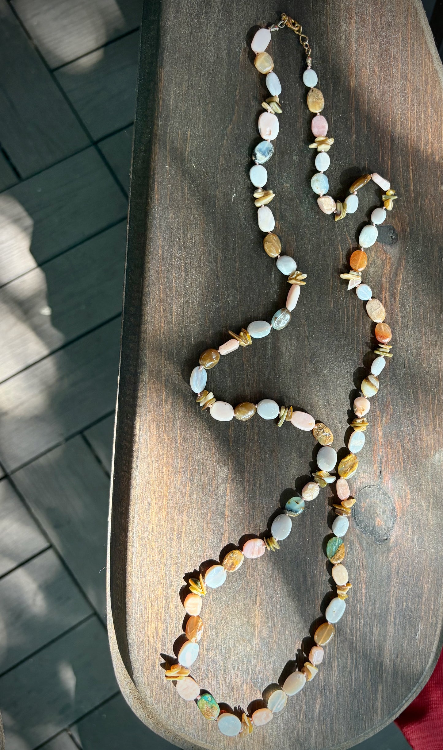 Multicolored beaded necklace on a wooden surface