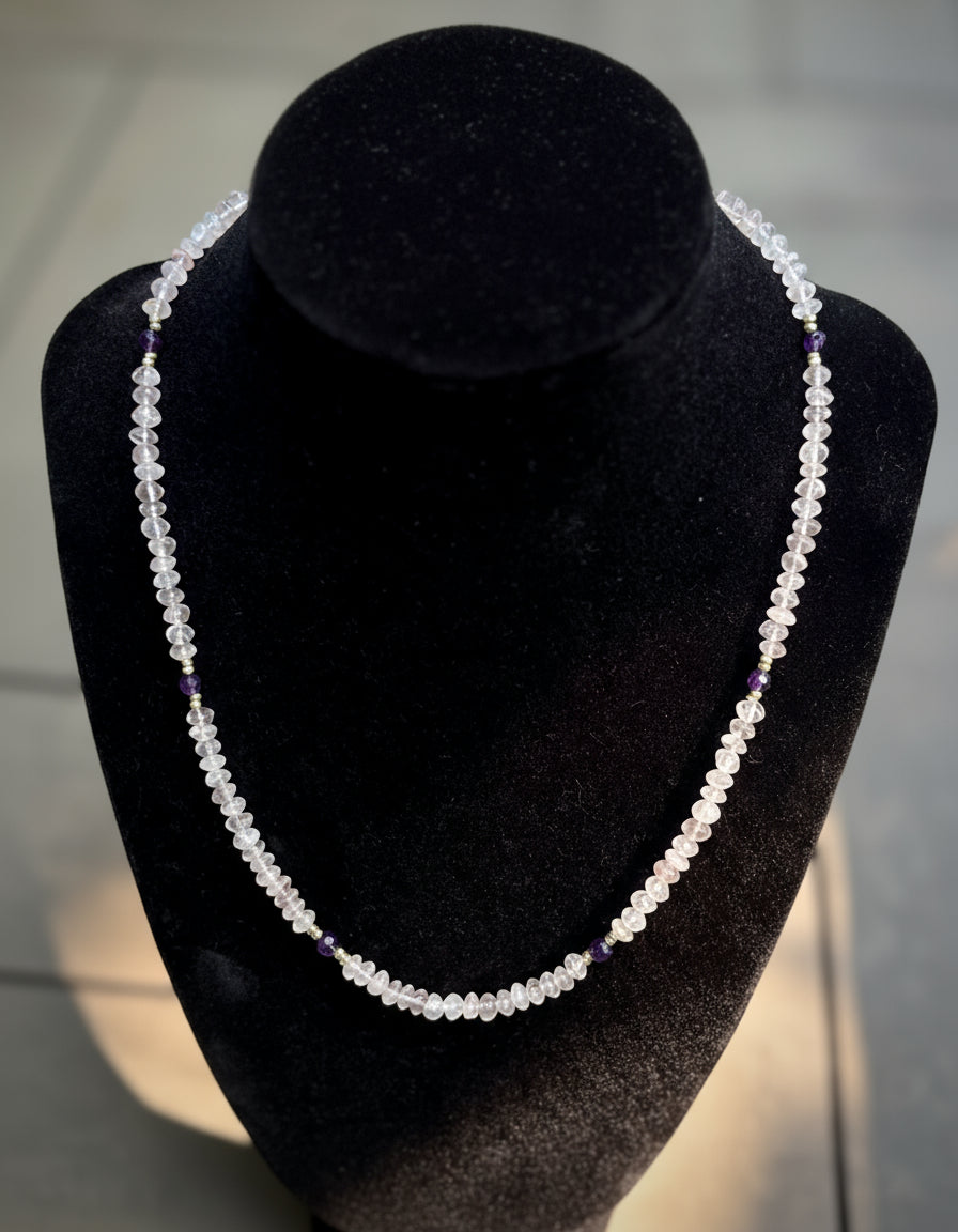 Rose quartz and amethyst necklace on a black velvet stand