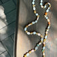 Multicolored beaded necklace on a wooden surface