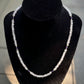 Rose quartz and amethyst necklace on a black velvet stand