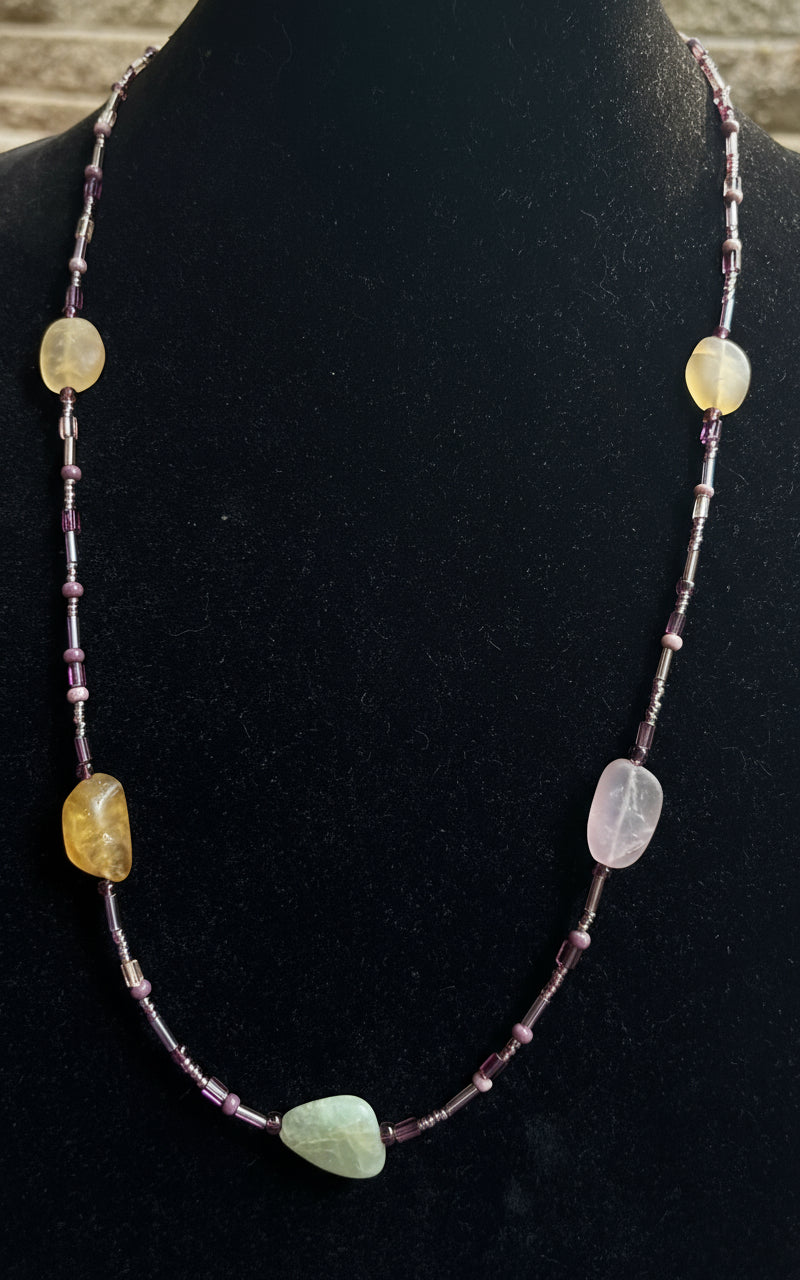 Necklace with multicolored beads on a black mannequin